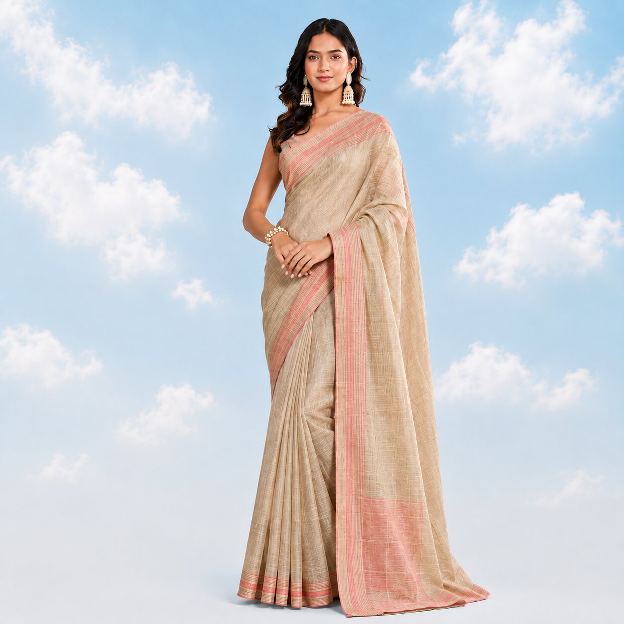 Model wearing a natural beige linen saree with a pink woven border